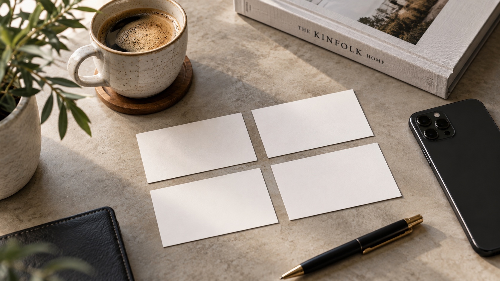 Four blank cards are arranged on a table.