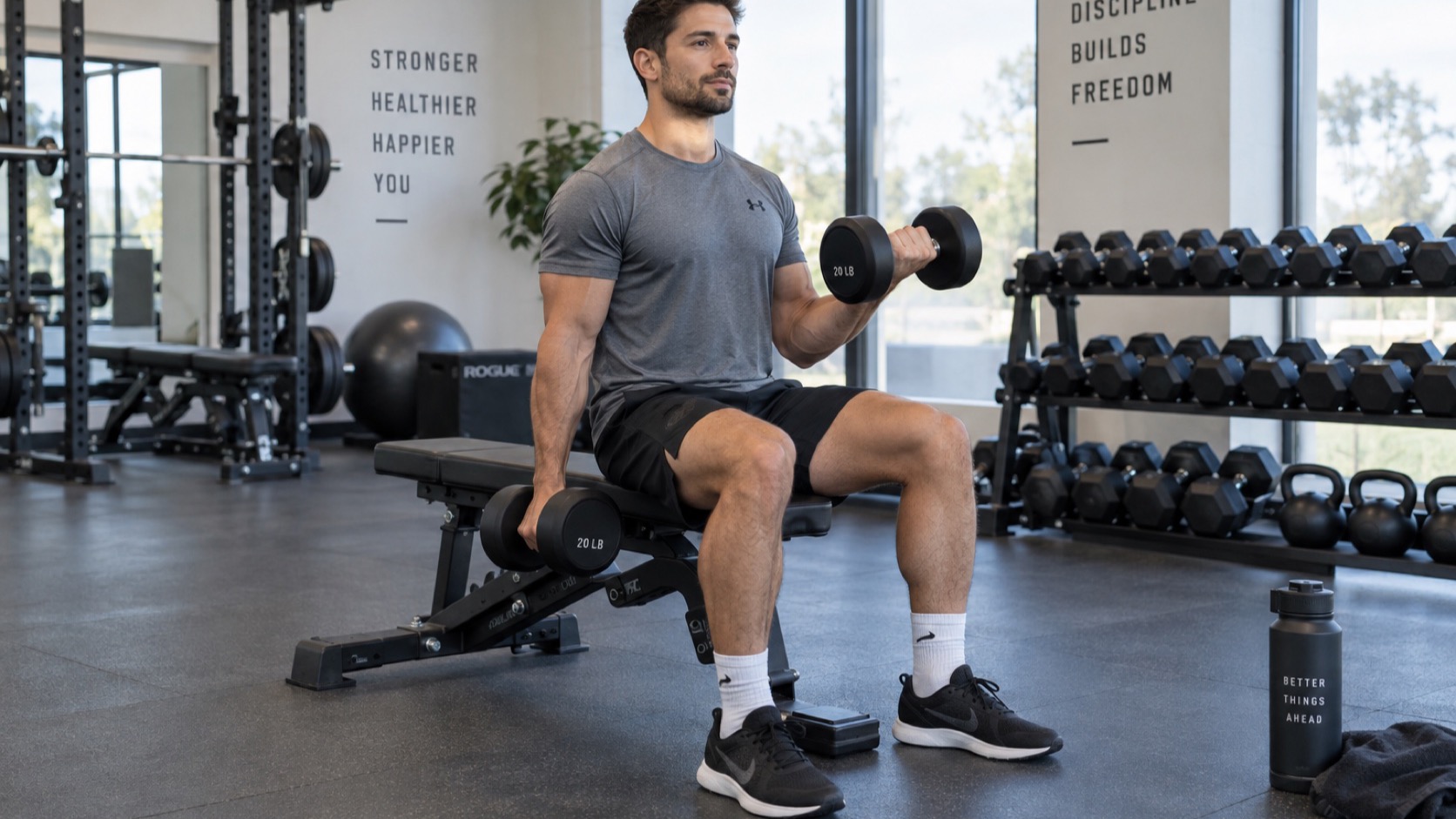 Adult lifts a light dumbbell with controlled form.